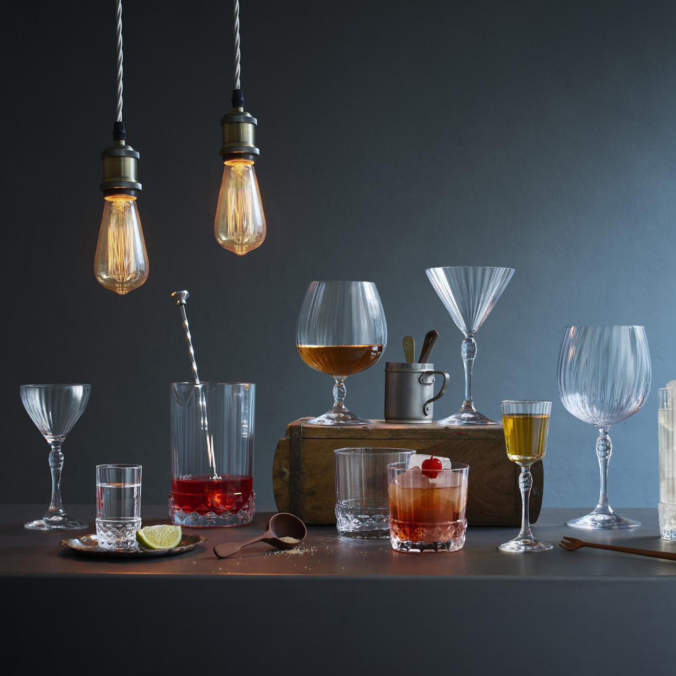 Speakeasy barware on a bar cart in a dark room