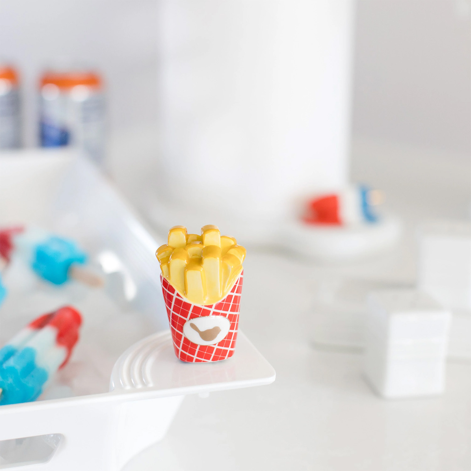 Nora Fleming mini Happy Fry Day shaped like a box of fast food french fries, attached to a base fille with popsicles
