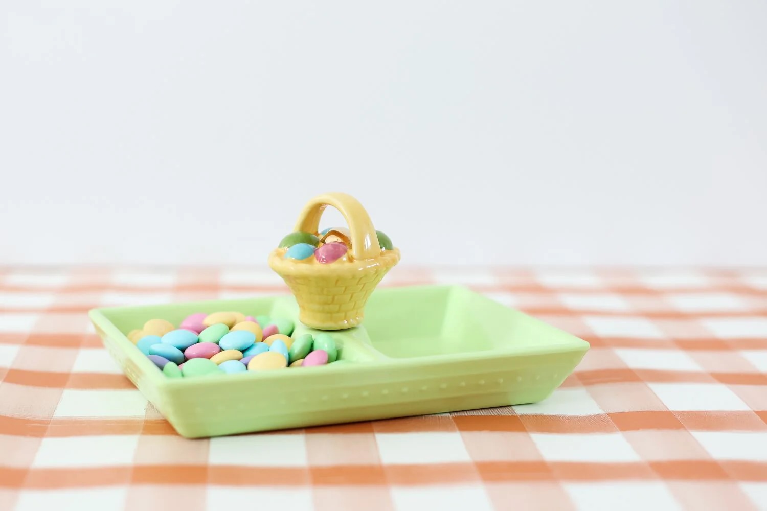 Nora Fleming Mini A Tisket, A Tasket, mini basket with eggs on a tray with candy