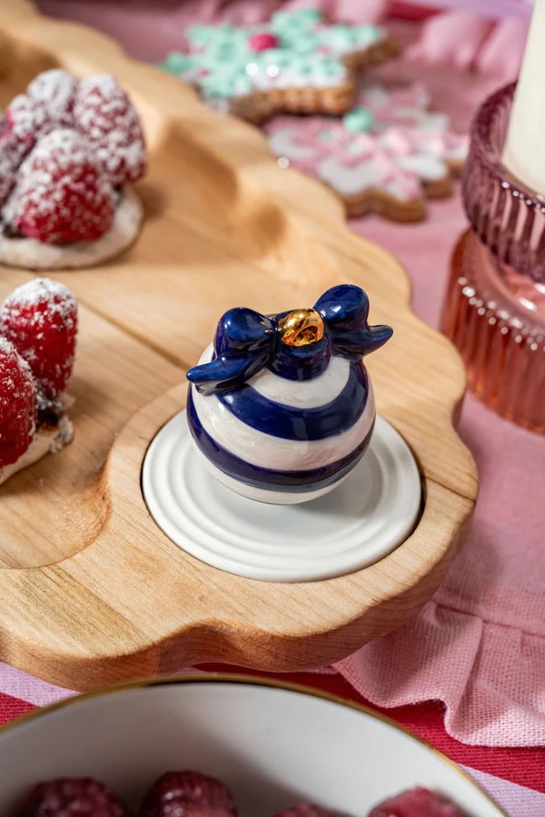 Nora Fleming Mini Deck the Hall Blue Christmas ornament on wooden serving tray