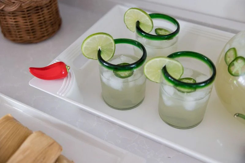 Nora Fleming Heat Wave chili pepper mini attached to a tray with cocktails