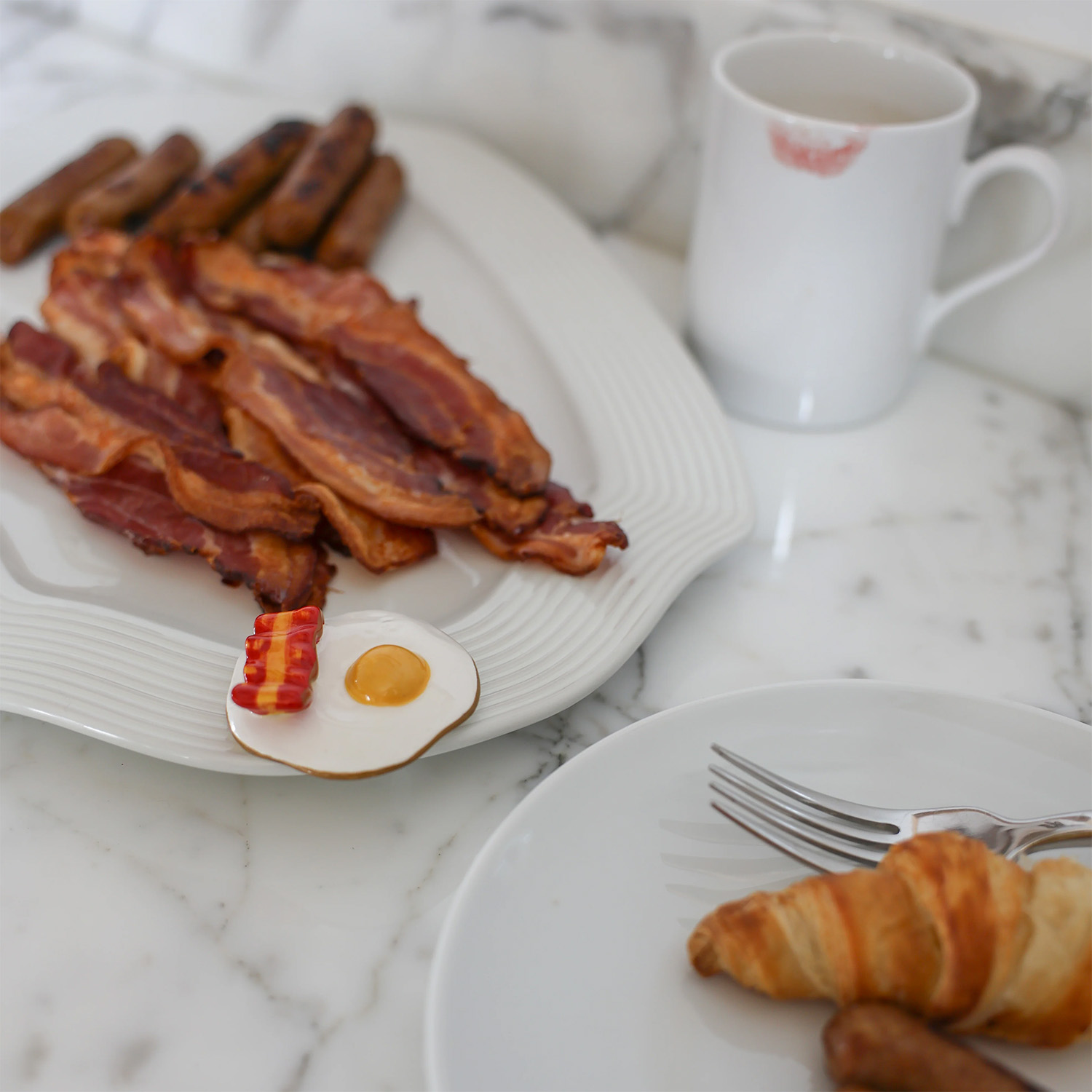 Wakey Wakey Nora Fleming Mini attached to a plate with bacon and sausage